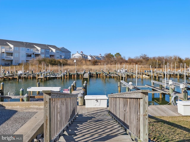 dock area featuring a residential view and a water view