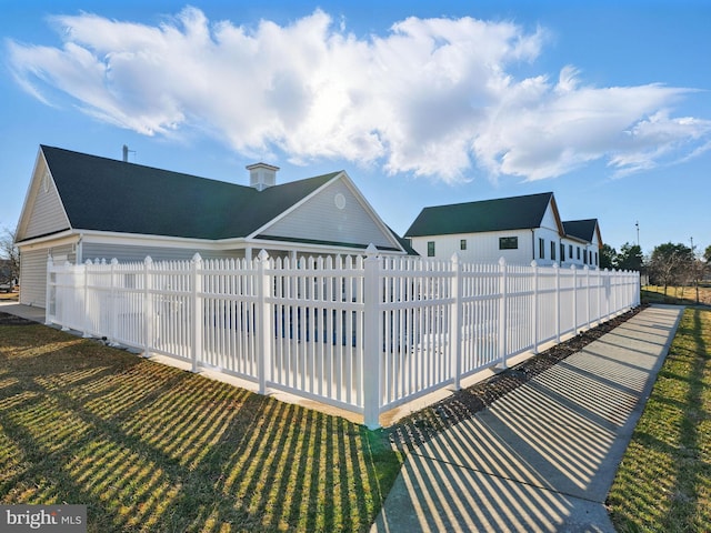 exterior space featuring a fenced front yard and a yard