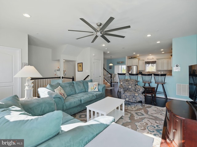 living room featuring light wood-style floors, stairway, recessed lighting, and visible vents