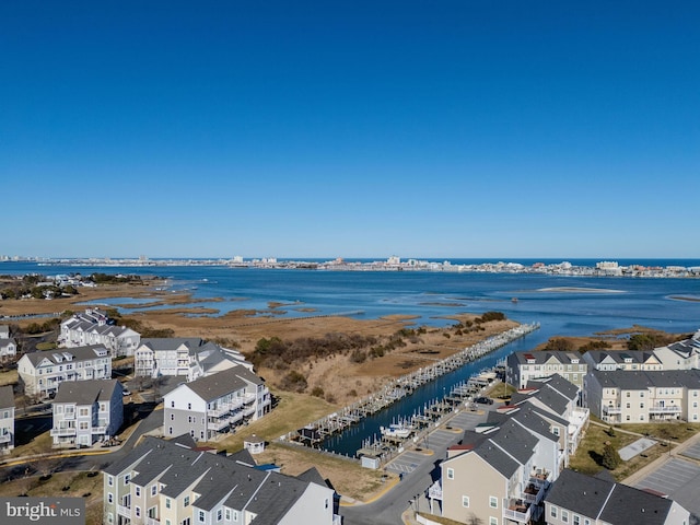 drone / aerial view featuring a residential view and a water view