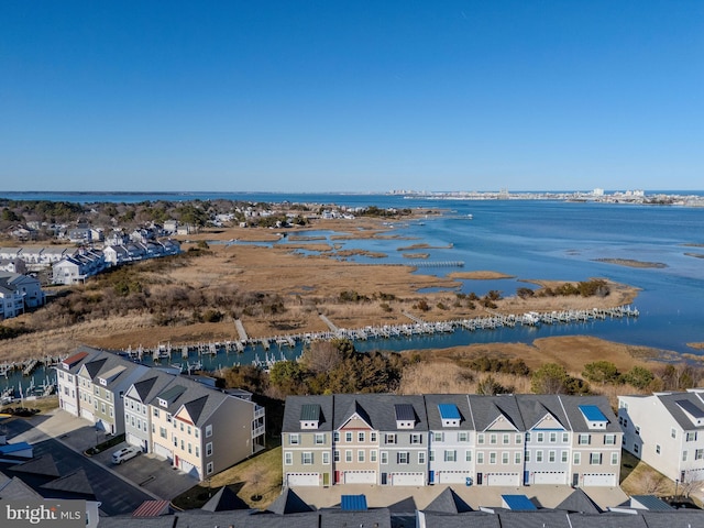 drone / aerial view featuring a residential view and a water view