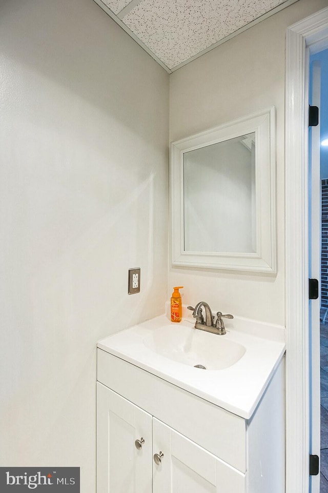 bathroom with vanity and a drop ceiling