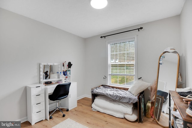 office featuring baseboards and light wood-style flooring