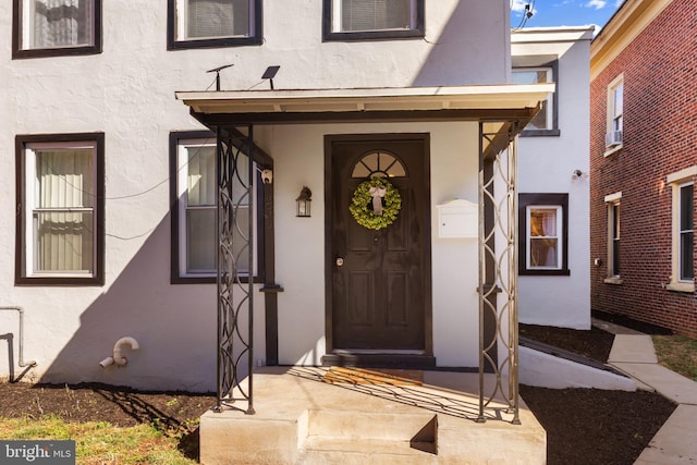 doorway to property with stucco siding