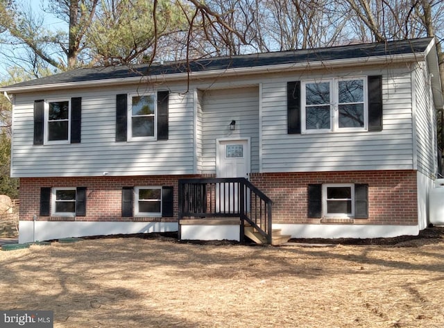 split foyer home with brick siding