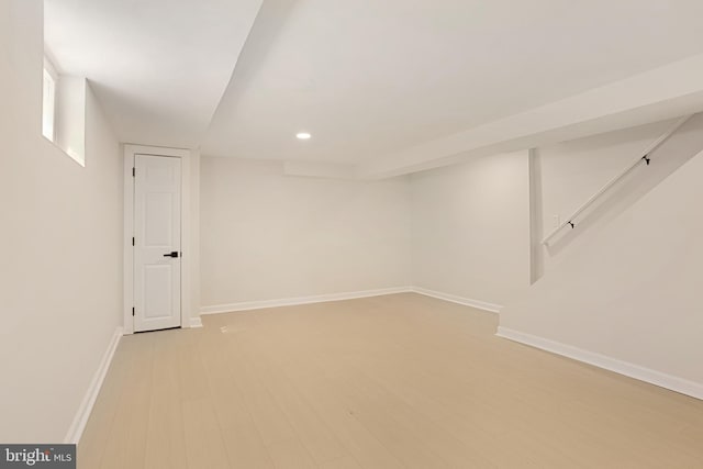 basement with recessed lighting, baseboards, and light wood-type flooring