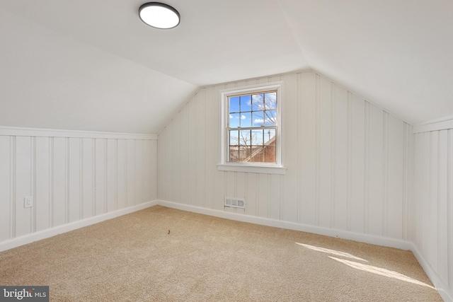 bonus room with lofted ceiling, carpet flooring, and visible vents