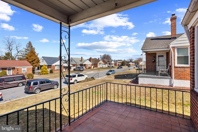 balcony featuring a residential view and covered porch