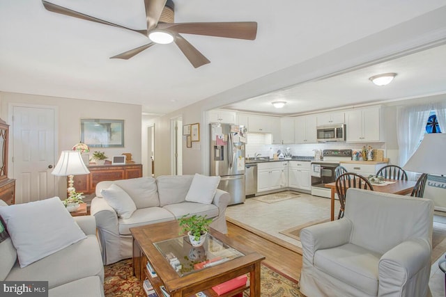 3719 3rd St, North Beach, MD 20714 - living area featuring light wood finished floors and ceiling fan