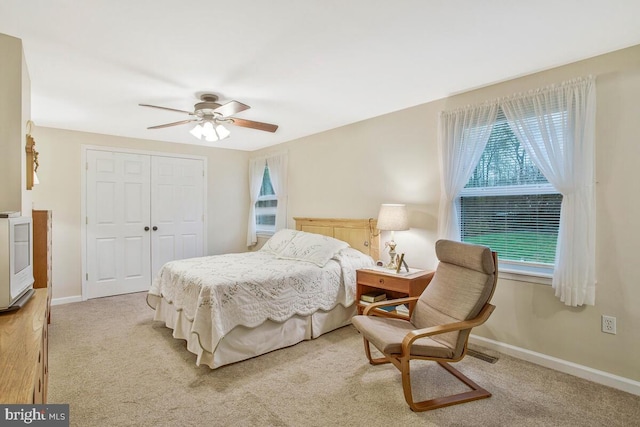 3719 3rd St, North Beach, MD 20714 - bedroom with a closet, light carpet, a ceiling fan, and baseboards