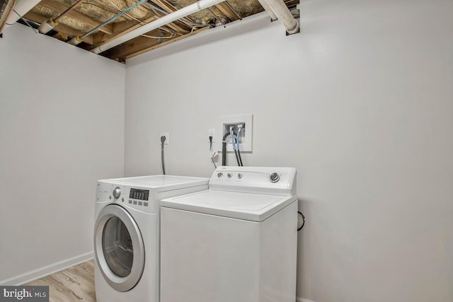 3719 3rd St, North Beach, MD 20714 - washroom featuring independent washer and dryer, light wood-style flooring, and baseboards