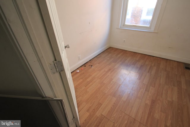 unfurnished bedroom with light wood finished floors and baseboards