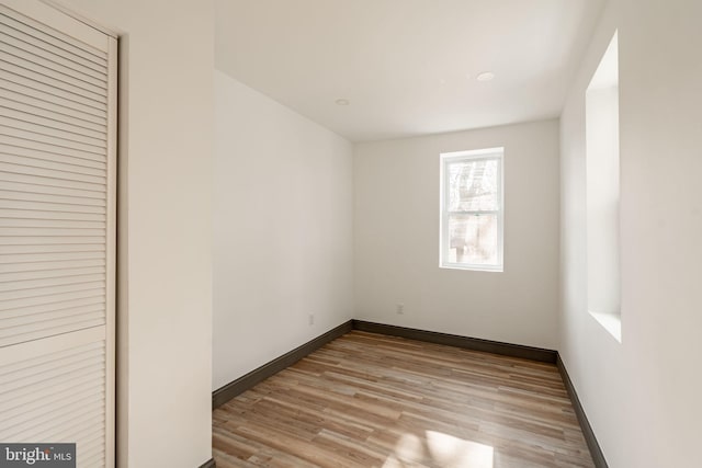 empty room featuring baseboards and wood finished floors