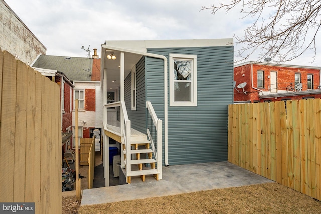 back of house with a patio and fence