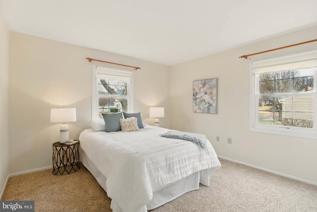 bedroom featuring baseboards and carpet