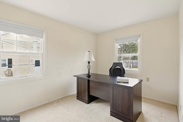 home office featuring baseboards and light carpet