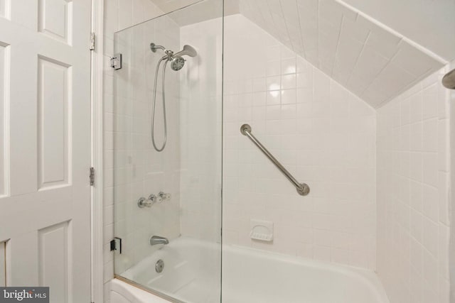 bathroom featuring enclosed tub / shower combo and lofted ceiling