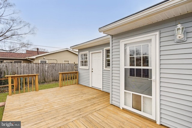 wooden terrace featuring fence