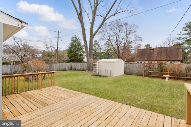 wooden deck featuring a storage shed, an outdoor structure, a fenced backyard, and a lawn