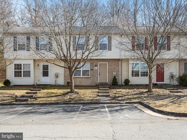 townhome / multi-family property featuring brick siding