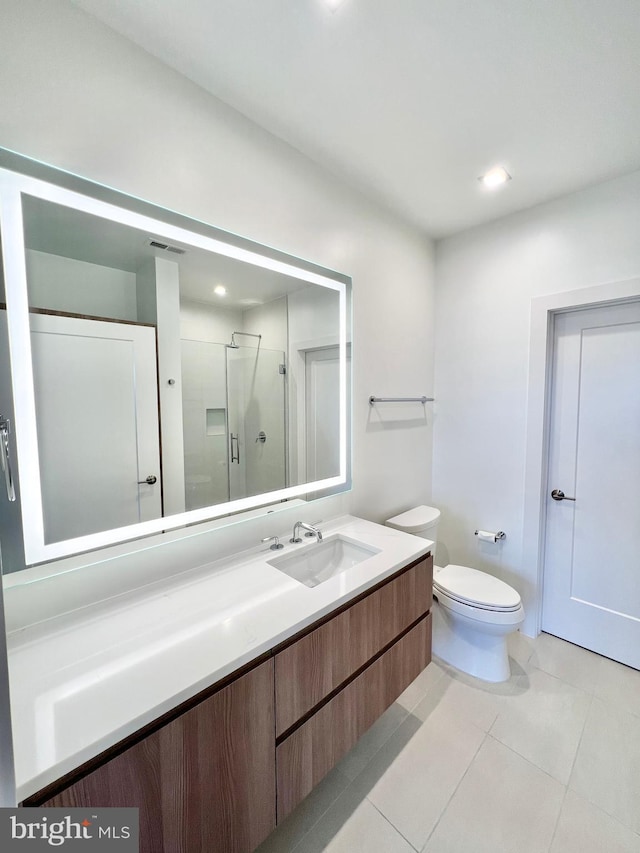 bathroom featuring toilet, recessed lighting, a stall shower, tile patterned floors, and vanity