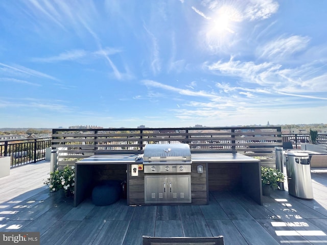 deck featuring area for grilling and a grill