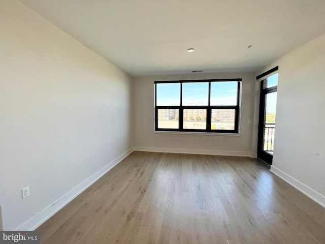 unfurnished room featuring baseboards and wood finished floors