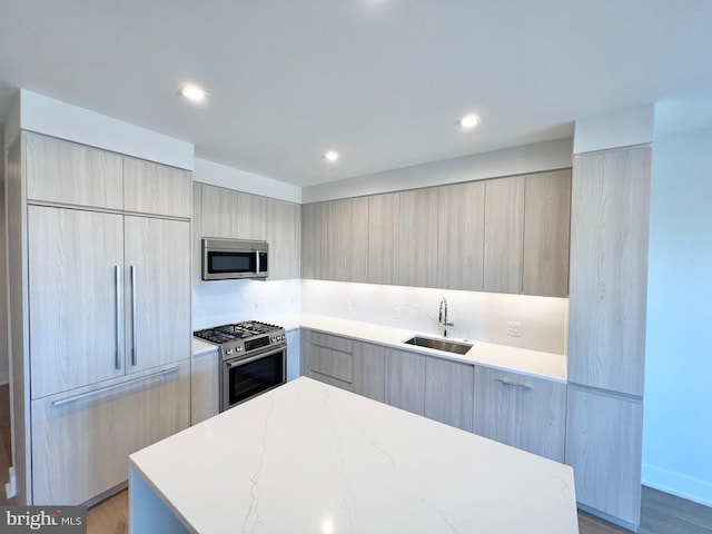 kitchen with recessed lighting, modern cabinets, appliances with stainless steel finishes, and a sink