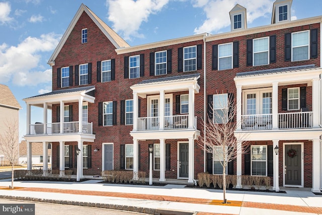 townhome / multi-family property with brick siding