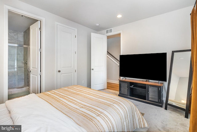 carpeted bedroom with recessed lighting, visible vents, and ensuite bathroom