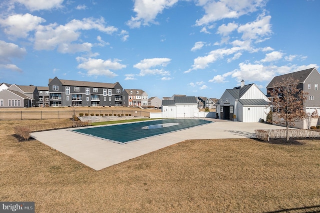 view of pool featuring a residential view, a yard, and fence