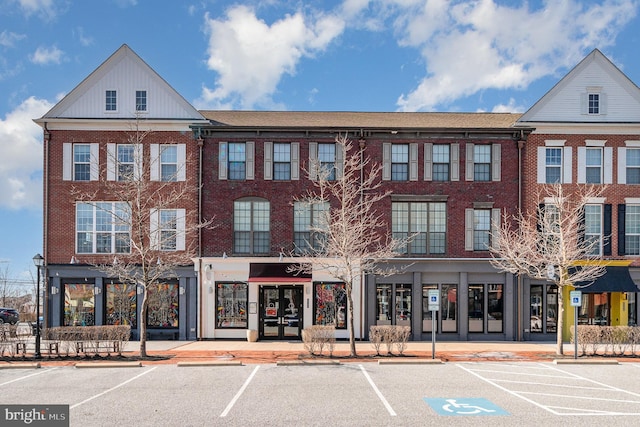 view of building exterior featuring uncovered parking