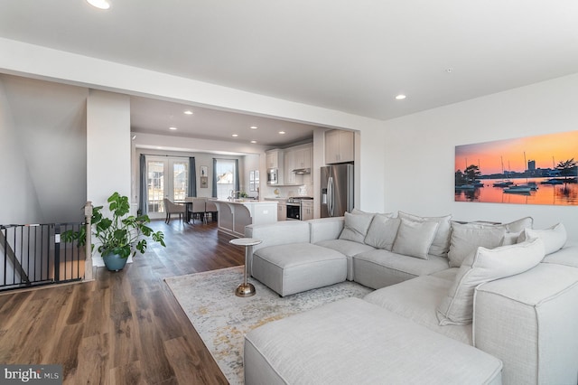 living area with recessed lighting and dark wood-style flooring