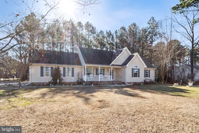 ranch-style home featuring a porch and a front lawn