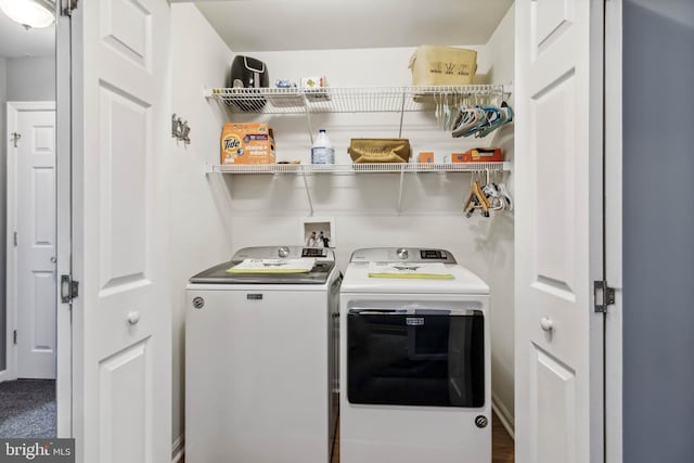 washroom featuring laundry area and washing machine and clothes dryer