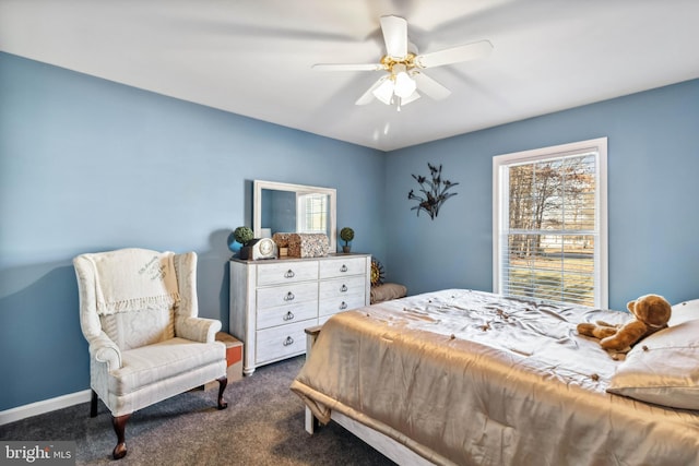 bedroom with multiple windows, baseboards, a ceiling fan, and dark colored carpet