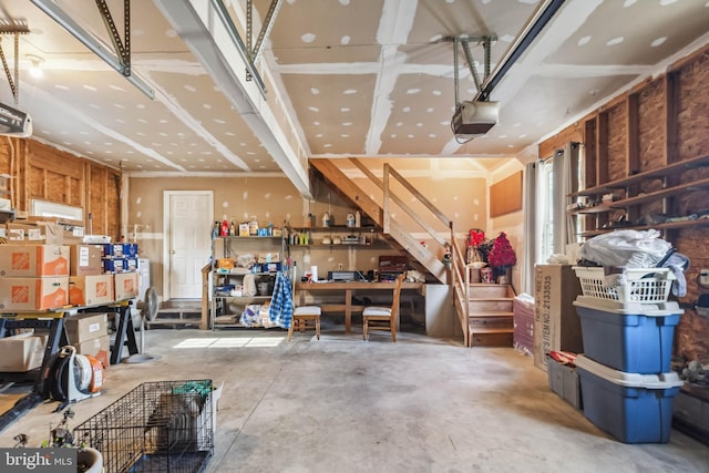 garage with a workshop area and a garage door opener