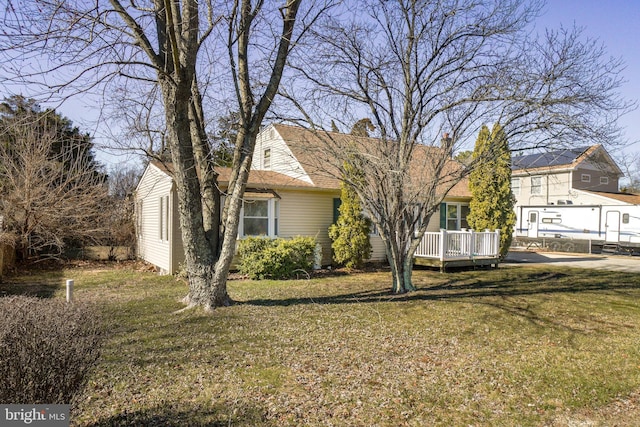 view of front of property with a shingled roof and a front lawn