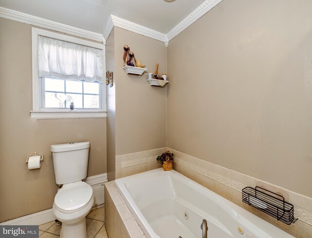 bathroom featuring a tub with jets, baseboards, crown molding, toilet, and tile patterned floors