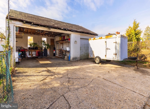 view of outdoor structure with an outbuilding and fence