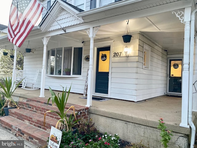 view of exterior entry with covered porch