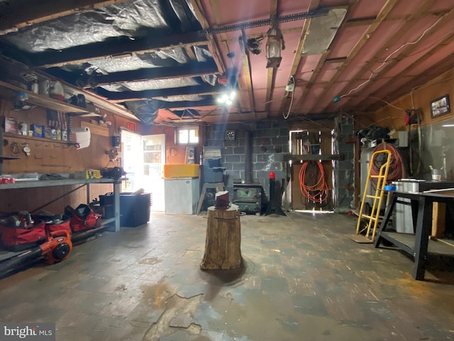 basement featuring a workshop area and concrete block wall