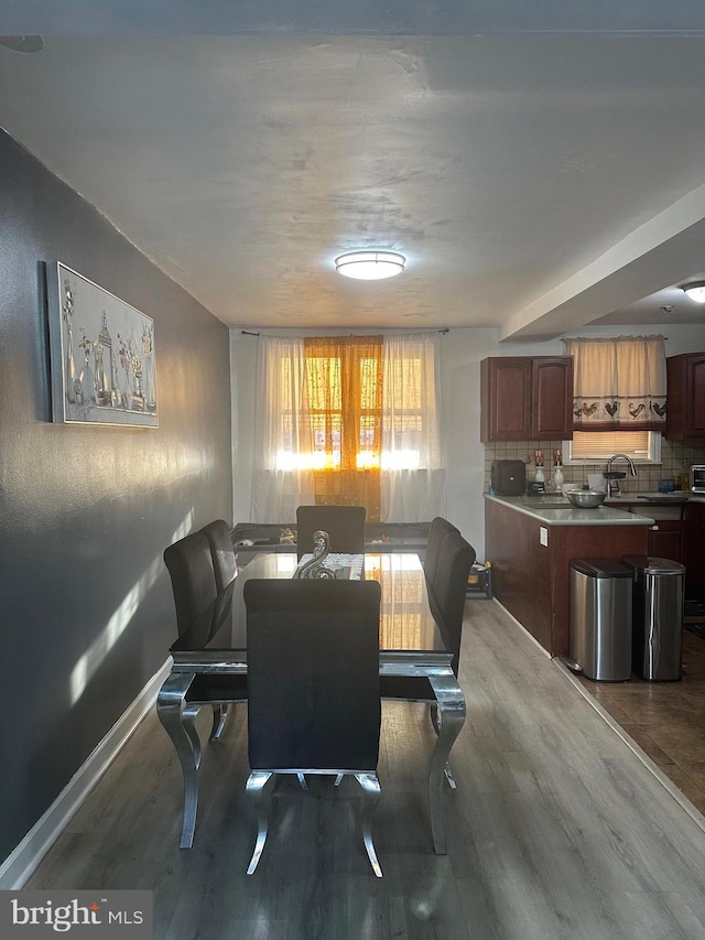 dining room with baseboards and wood finished floors