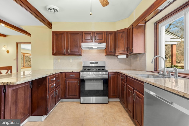 kitchen featuring visible vents, under cabinet range hood, a sink, appliances with stainless steel finishes, and a peninsula