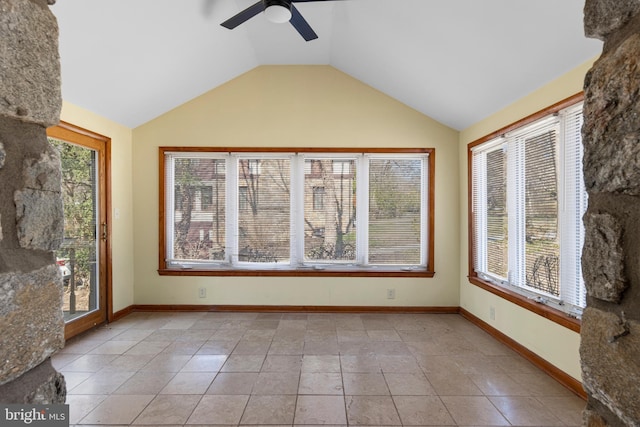 unfurnished sunroom featuring a ceiling fan and vaulted ceiling