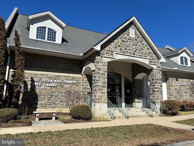 french country inspired facade with stone siding