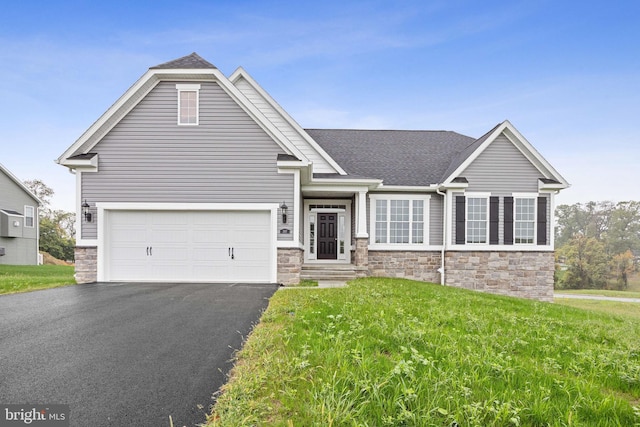 view of front of property featuring aphalt driveway, stone siding, roof with shingles, and a front lawn