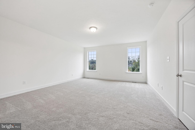 empty room with carpet flooring and baseboards