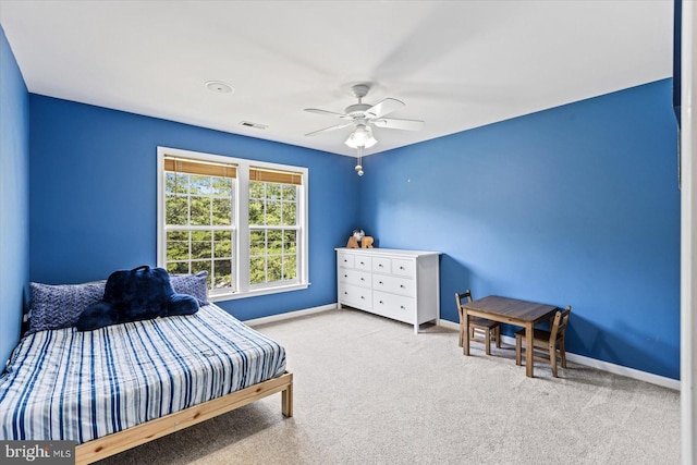 carpeted bedroom with visible vents, baseboards, and ceiling fan