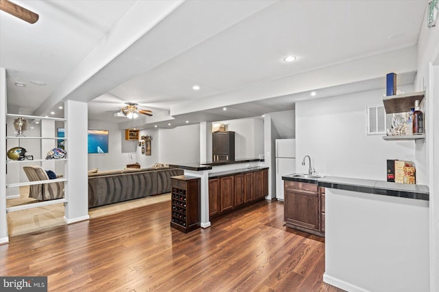 kitchen with dark wood-type flooring, recessed lighting, freestanding refrigerator, a ceiling fan, and a sink